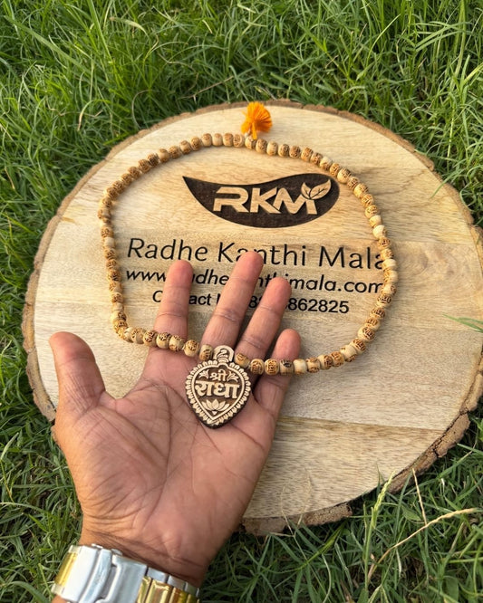 Close-up of Radha Name locket on Tulsi Mala