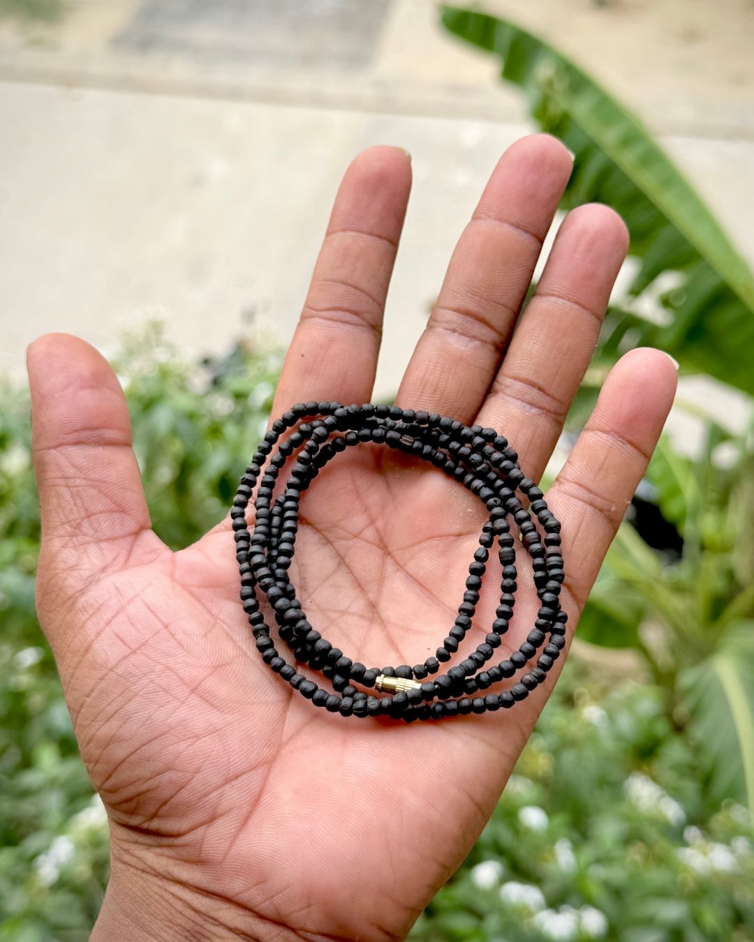 Close up of 2 Round Black Tulsi Mala with polished round black Tulsi beads