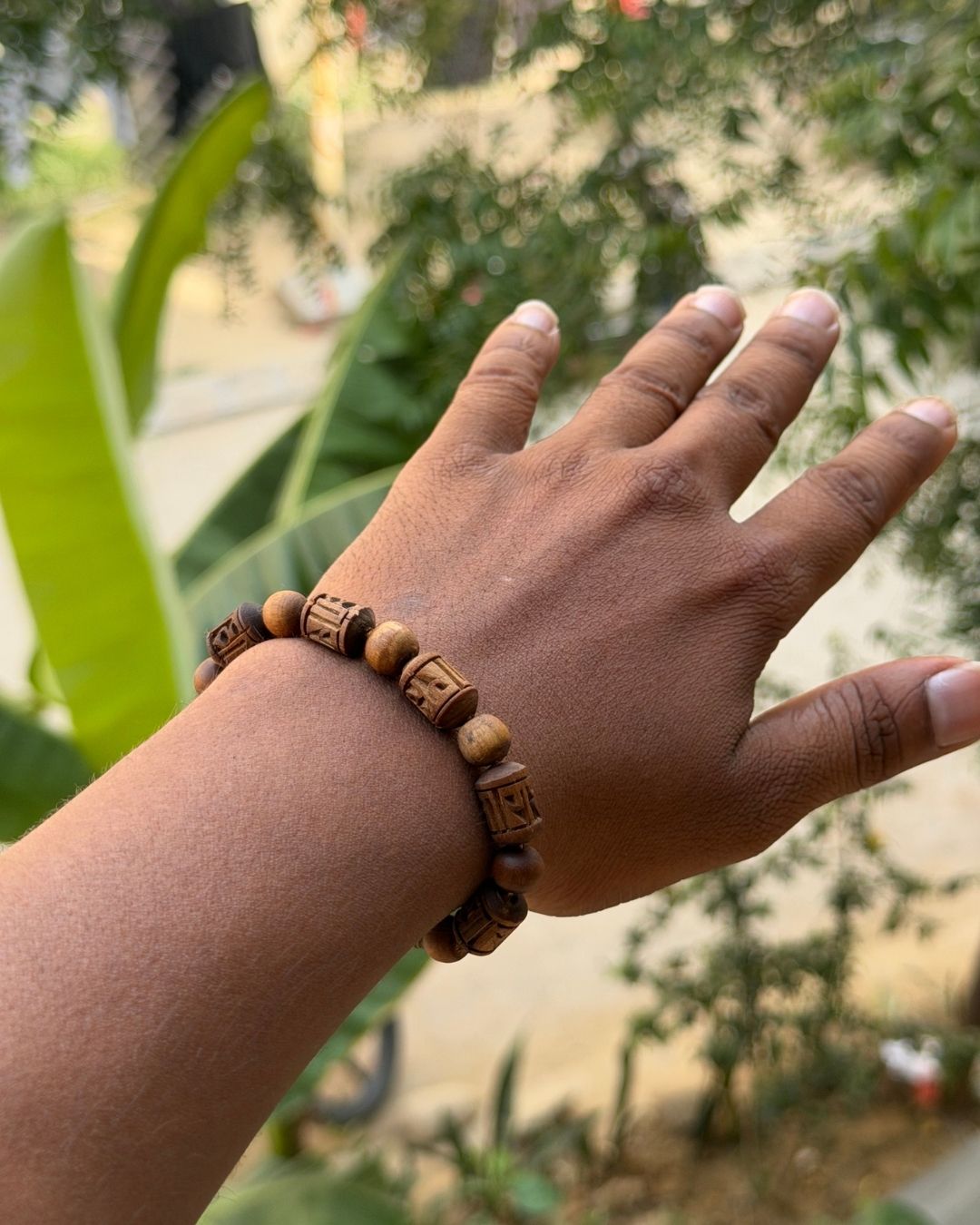 Side view of Radha Name Brown Tulsi Bracelet with round Tulsi beads