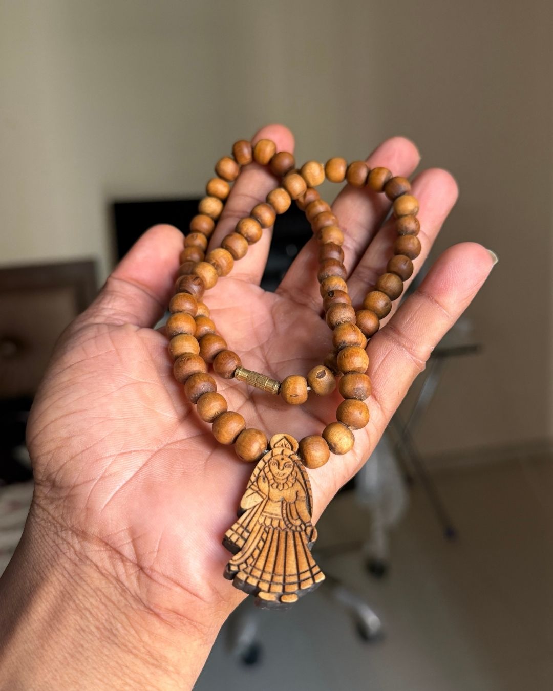 Close-up view of Shri Radha Locket Mala with dark brown Tulsi beads and Radha locket