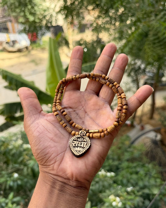 Close up of Shri Radha Locket and Radha Name Brown Tulsi Mala with round Tulsi beads