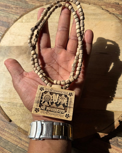 Flat lay image of Shri Shriman Narayan Bhaktmal Tulsi Mala with natural Tulsi wood beads