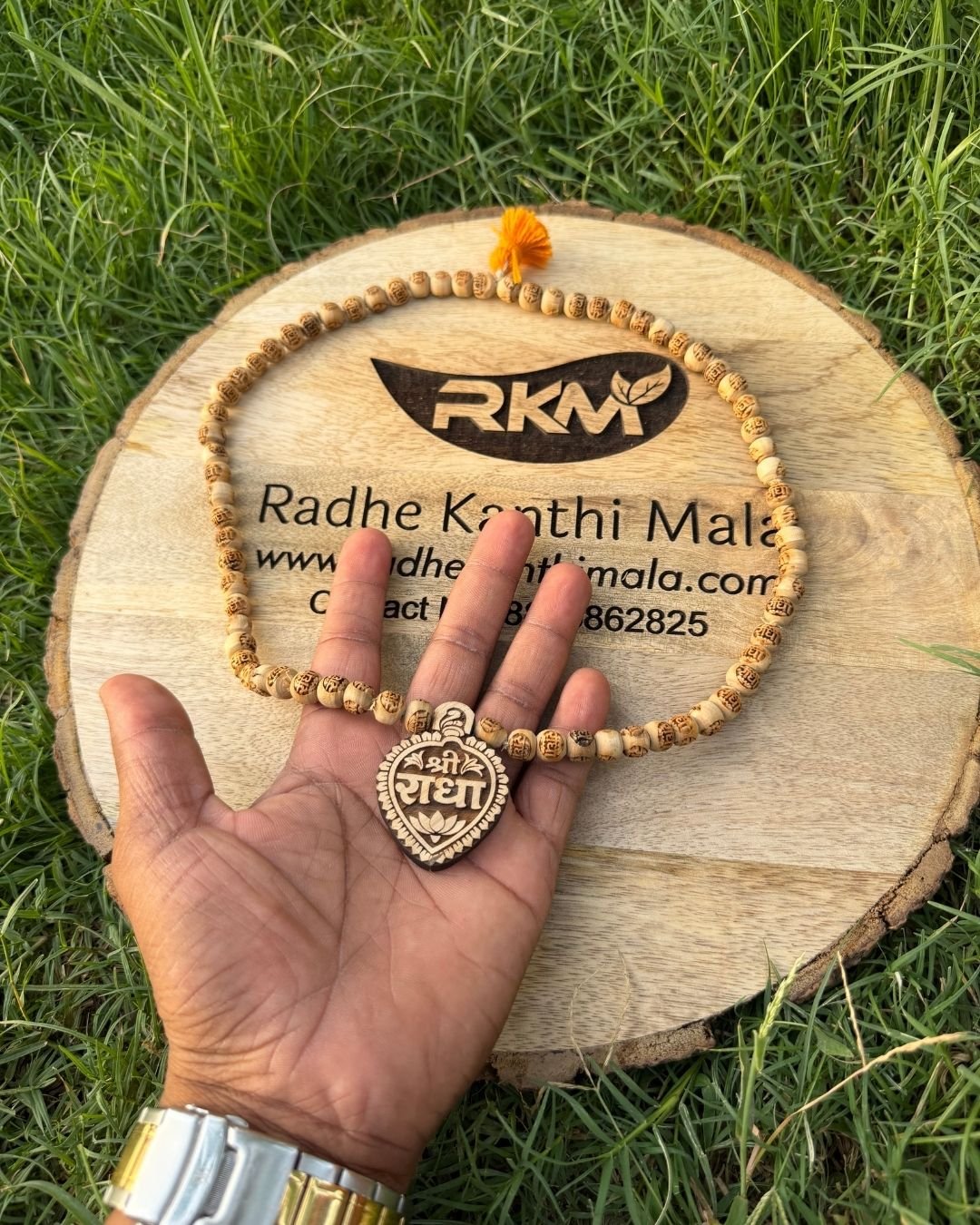 Close-up of Radha Name locket on Tulsi Mala