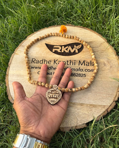 Close-up of Radha Name locket on Tulsi Mala